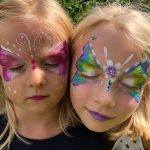 Bunte Schmetterlinge im Gesicht geschminkt